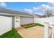 This backyard has a concrete patio, grass, and a wooden privacy fence at 13712 Bonnerby Ct, Huntersville, NC 28078