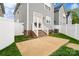 This backyard has a concrete patio, grass, stairs, and a white privacy fence at 13712 Bonnerby Ct, Huntersville, NC 28078