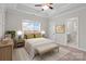 Bedroom with a tray ceiling, carpeted floors, a Queen bed, and an entrance to a full bathroom at 13712 Bonnerby Ct, Huntersville, NC 28078