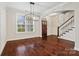 Bright dining area with hardwood floors, stylish lighting, and easy access to the staircase at 13712 Bonnerby Ct, Huntersville, NC 28078