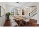 Elegant dining room featuring hardwood floors, large windows, and a modern chandelier at 13712 Bonnerby Ct, Huntersville, NC 28078