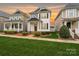 Charming two-story home featuring a manicured lawn and beautifully landscaped front yard with craftsman details at 13712 Bonnerby Ct, Huntersville, NC 28078