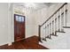 Bright entryway featuring hardwood floors, a stylish staircase and decorative trim at 13712 Bonnerby Ct, Huntersville, NC 28078