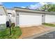 This is a two car garage with gray siding, a concrete driveway, and green grass at 13712 Bonnerby Ct, Huntersville, NC 28078