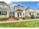 This home has gray siding, a well manicured lawn, and beautiful architectural details at 13712 Bonnerby Ct, Huntersville, NC 28078