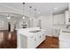 Modern kitchen features a spacious island with white countertop and dark hardwood floors at 13712 Bonnerby Ct, Huntersville, NC 28078