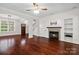 Comfortable living room with a fireplace, built-in shelves, and beautiful hardwood floors at 13712 Bonnerby Ct, Huntersville, NC 28078