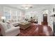 Inviting living room with hardwood floors, neutral decor, and large windows for ample natural light at 13712 Bonnerby Ct, Huntersville, NC 28078