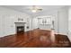 Open living area with a stylish fireplace, hardwood floors, and seamless flow to the kitchen at 13712 Bonnerby Ct, Huntersville, NC 28078