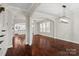 Open-concept living space showcasing hardwood floors, arched doorways, and abundant natural light at 13712 Bonnerby Ct, Huntersville, NC 28078