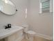 Well-lit powder room with a pedestal sink, modern faucet, toilet, and window at 1378 Cedardale Ln, Denver, NC 28037