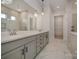 Spacious primary bathroom featuring double sinks, marble flooring, and a walk-in closet at 1378 Cedardale Ln, Denver, NC 28037