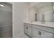 Bathroom featuring double sink vanity with neutral cabinets, marble-look tile flooring, and a large mirror at 1378 Cedardale Ln, Denver, NC 28037