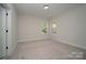 Bedroom featuring neutral walls, carpeted floors, and natural light from two windows at 1378 Cedardale Ln, Denver, NC 28037