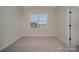 Bedroom featuring neutral walls, carpeted floors, and a large window at 1378 Cedardale Ln, Denver, NC 28037