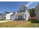 Charming two-story home with gray siding, a covered porch, and manicured landscaping at 1378 Cedardale Ln, Denver, NC 28037