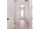 Hallway with white walls, baseboards and door, hardwood floors, and recessed lighting at 1378 Cedardale Ln, Denver, NC 28037