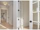 Hallway with hardwood floors, white trim, and french doors at 1378 Cedardale Ln, Denver, NC 28037