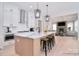 Bright, open kitchen boasts marble countertops, stainless steel appliances, and a view into the cozy living room at 1378 Cedardale Ln, Denver, NC 28037