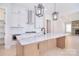 This spacious kitchen features white cabinets, stainless steel appliances, and a center island with marble countertops at 1378 Cedardale Ln, Denver, NC 28037