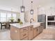 Open concept kitchen with large island, farmhouse sink, stainless appliances and adjacent dining area at 1378 Cedardale Ln, Denver, NC 28037
