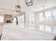 Bright open-concept kitchen with marble countertops, pendant lighting, and view to the fireplace at 1378 Cedardale Ln, Denver, NC 28037