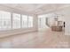 Open-concept living room with hardwood floors, coffered ceiling, fireplace, and large windows at 1378 Cedardale Ln, Denver, NC 28037