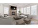 Cozy living room features a stone fireplace, large windows, and comfortable seating at 1378 Cedardale Ln, Denver, NC 28037