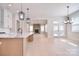 Open-concept living space with hardwood floors connects a modern kitchen to a comfortable living room with a stone fireplace at 1378 Cedardale Ln, Denver, NC 28037