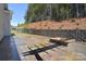 Open patio area with a stone fire pit and retaining wall, offering a great space for outdoor relaxation at 1378 Cedardale Ln, Denver, NC 28037