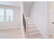 Bright stairway with light hardwood steps, white risers, and a black metal railing at 1378 Cedardale Ln, Denver, NC 28037
