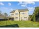 Large backyard with lush green lawn, complementing the two-story home, perfect for outdoor enjoyment at 15402 Country Lake Dr, Pineville, NC 28134
