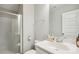 Clean bathroom features a white vanity with a modern faucet, toilet, tiled floors, and a tiled shower at 15402 Country Lake Dr, Pineville, NC 28134