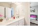 Bathroom featuring double sinks, marble countertops, and modern fixtures at 15402 Country Lake Dr, Pineville, NC 28134