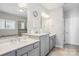 Bathroom features double sink vanity with marble countertops, and a glass enclosed shower for spa-like experience at 15402 Country Lake Dr, Pineville, NC 28134
