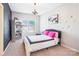 Bright bedroom features a modern chandelier, cozy carpet, and creative chalkboard wall at 15402 Country Lake Dr, Pineville, NC 28134