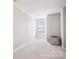 Neutral bedroom with lots of natural light from the window, and a small fridge in the corner at 15402 Country Lake Dr, Pineville, NC 28134