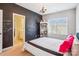 Bright bedroom featuring a modern chandelier, cozy carpet, and creative chalkboard wall at 15402 Country Lake Dr, Pineville, NC 28134