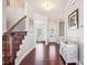 Welcoming foyer with hardwood floors, a staircase with iron spindles, and ample natural light at 15402 Country Lake Dr, Pineville, NC 28134