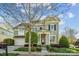 Charming two-story home with well-maintained landscaping, mature trees, and inviting entrance at 15402 Country Lake Dr, Pineville, NC 28134