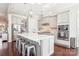Stylish kitchen with gray cabinetry, stainless steel appliances, an island with seating, and pendant lighting at 15402 Country Lake Dr, Pineville, NC 28134