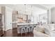 Modern kitchen featuring gray cabinets, large island with seating, stainless steel appliances, and pendant lights at 15402 Country Lake Dr, Pineville, NC 28134