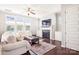 Cozy living room with a fireplace, large windows, and comfortable seating at 15402 Country Lake Dr, Pineville, NC 28134