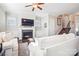 Bright living room featuring a fireplace, hardwood floors, and staircase access at 15402 Country Lake Dr, Pineville, NC 28134