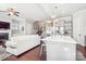 Open-concept living space features a kitchen, living room with fireplace, and staircase to the upper level at 15402 Country Lake Dr, Pineville, NC 28134