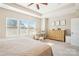 Sunlit bedroom with large windows, decorative desk, classic dresser, and neutral walls create a peaceful retreat at 15402 Country Lake Dr, Pineville, NC 28134