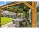 Outdoor patio featuring a covered gazebo with a dining set, heater, and charming string lights at 15402 Country Lake Dr, Pineville, NC 28134