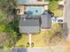 Overhead shot of house with backyard pool, deck, mature trees, three parked cars, and manicured lawn at 1736 Cavendale Dr, Rock Hill, SC 29732