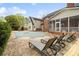 Backyard oasis with a covered pool, brick patio, and lounge chairs for relaxing outdoors at 1736 Cavendale Dr, Rock Hill, SC 29732