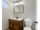 Bathroom featuring a vanity with wooden cabinets, light beige sink and a window for natural light at 1736 Cavendale Dr, Rock Hill, SC 29732